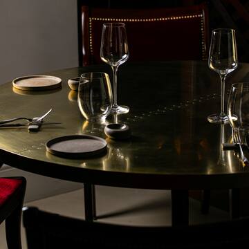 a table with wine glasses and utensils