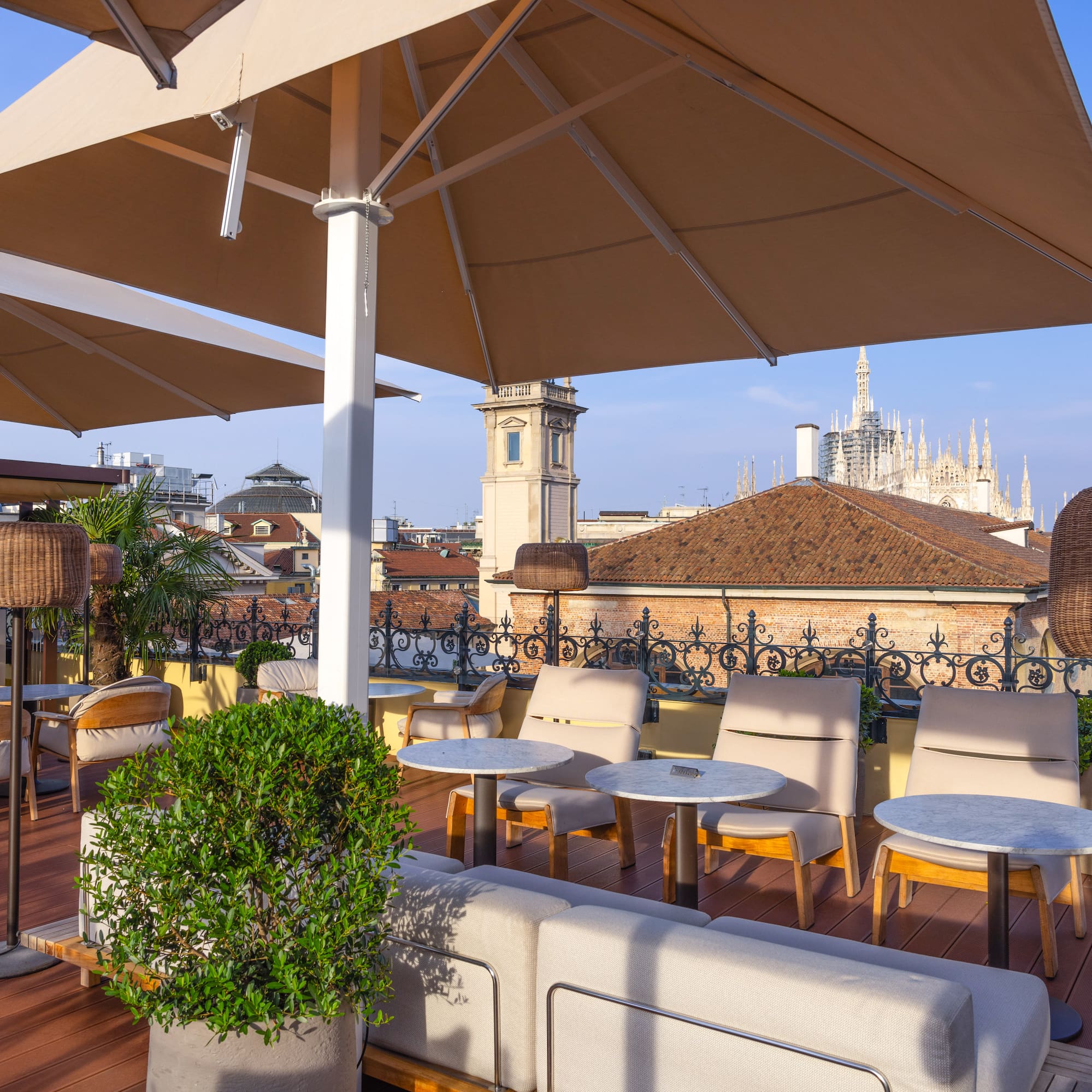 a patio with chairs and umbrellas