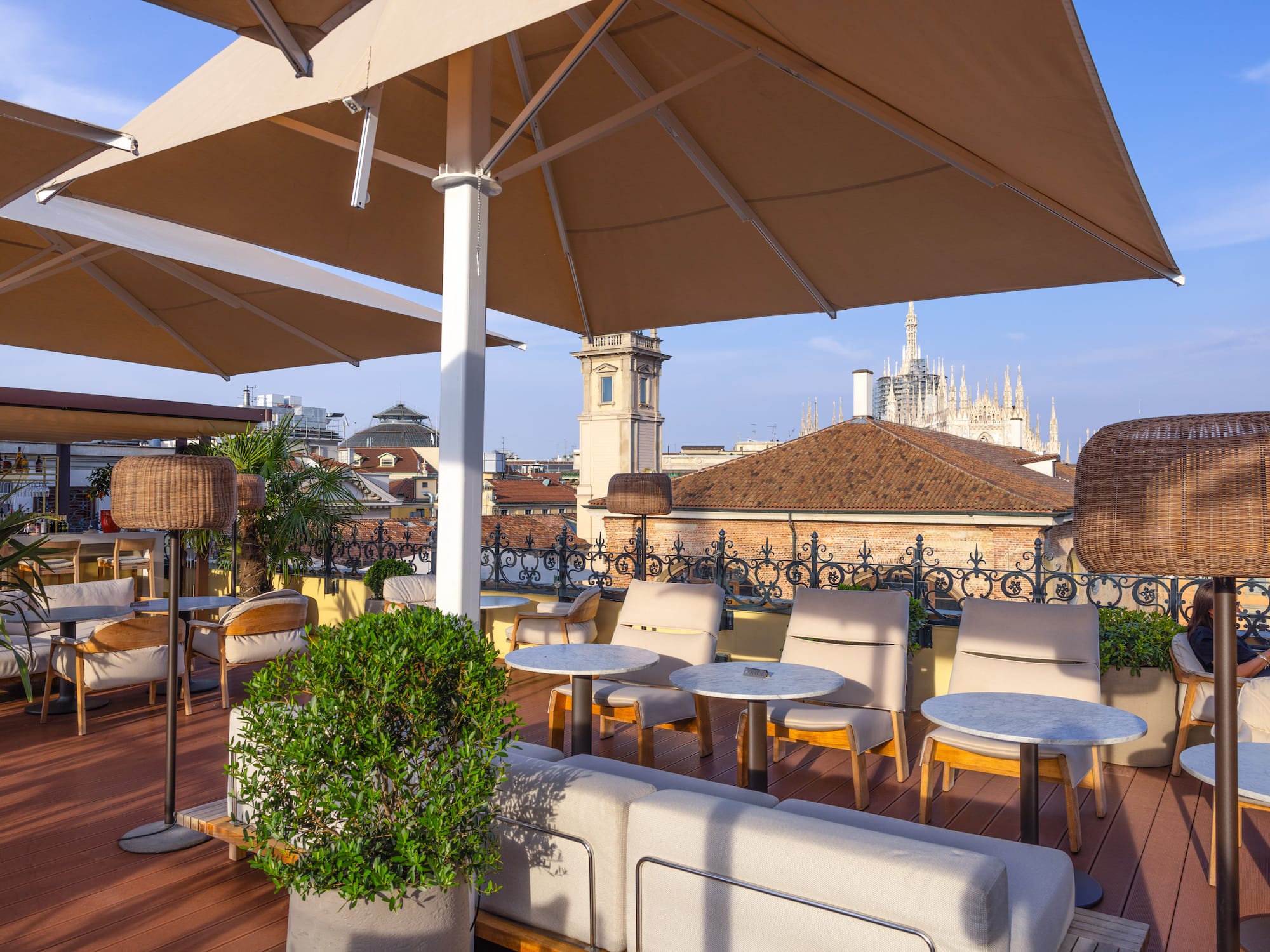 a patio with chairs and umbrellas