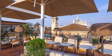 a patio with chairs and umbrellas