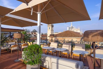 a patio with chairs and umbrellas