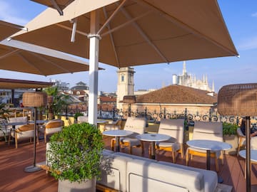 a patio with chairs and umbrellas