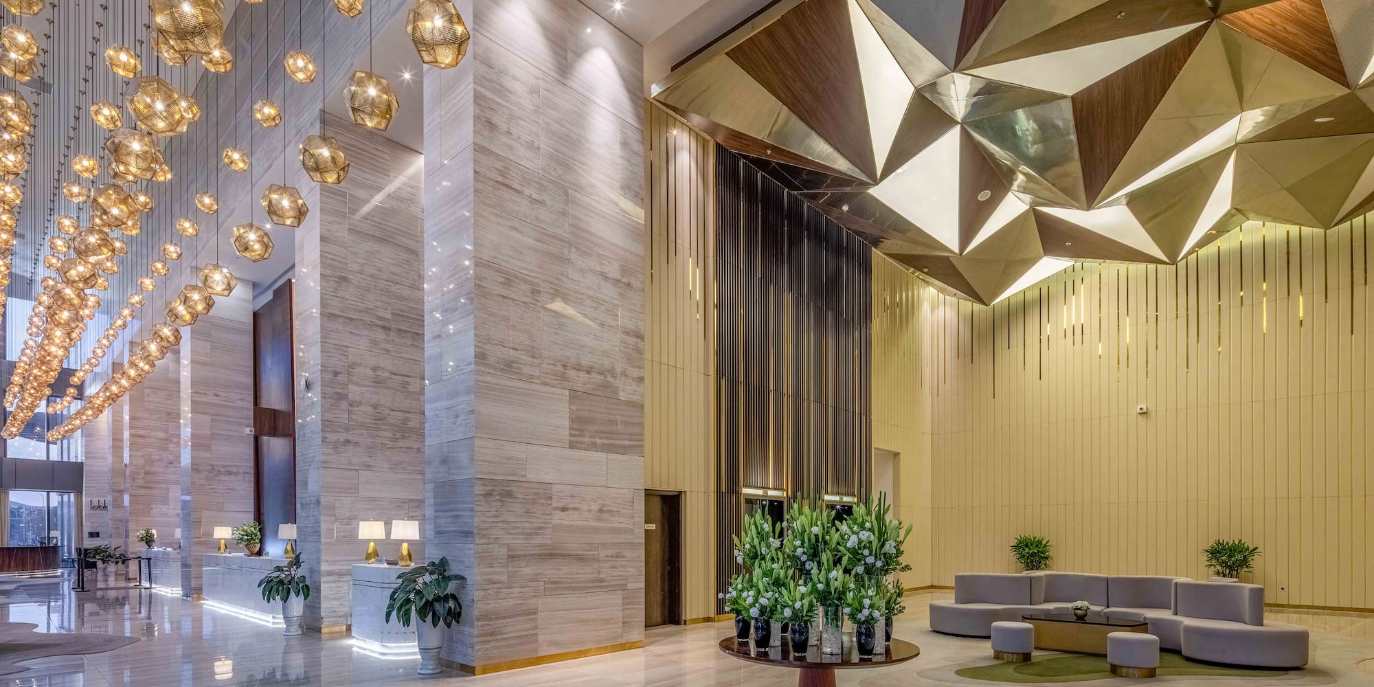 a lobby with a large chandelier and a couch