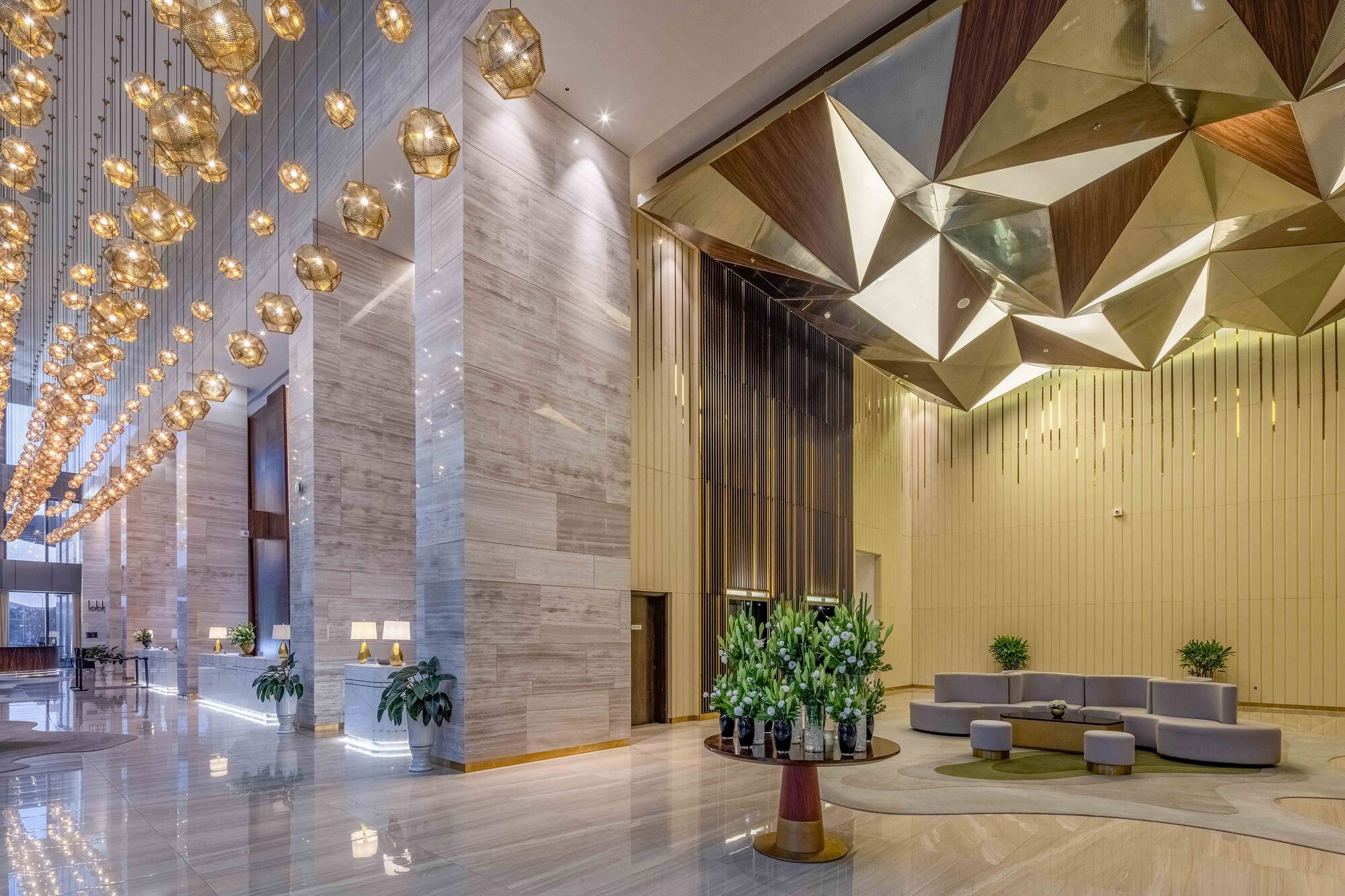 a lobby with a large chandelier and a couch