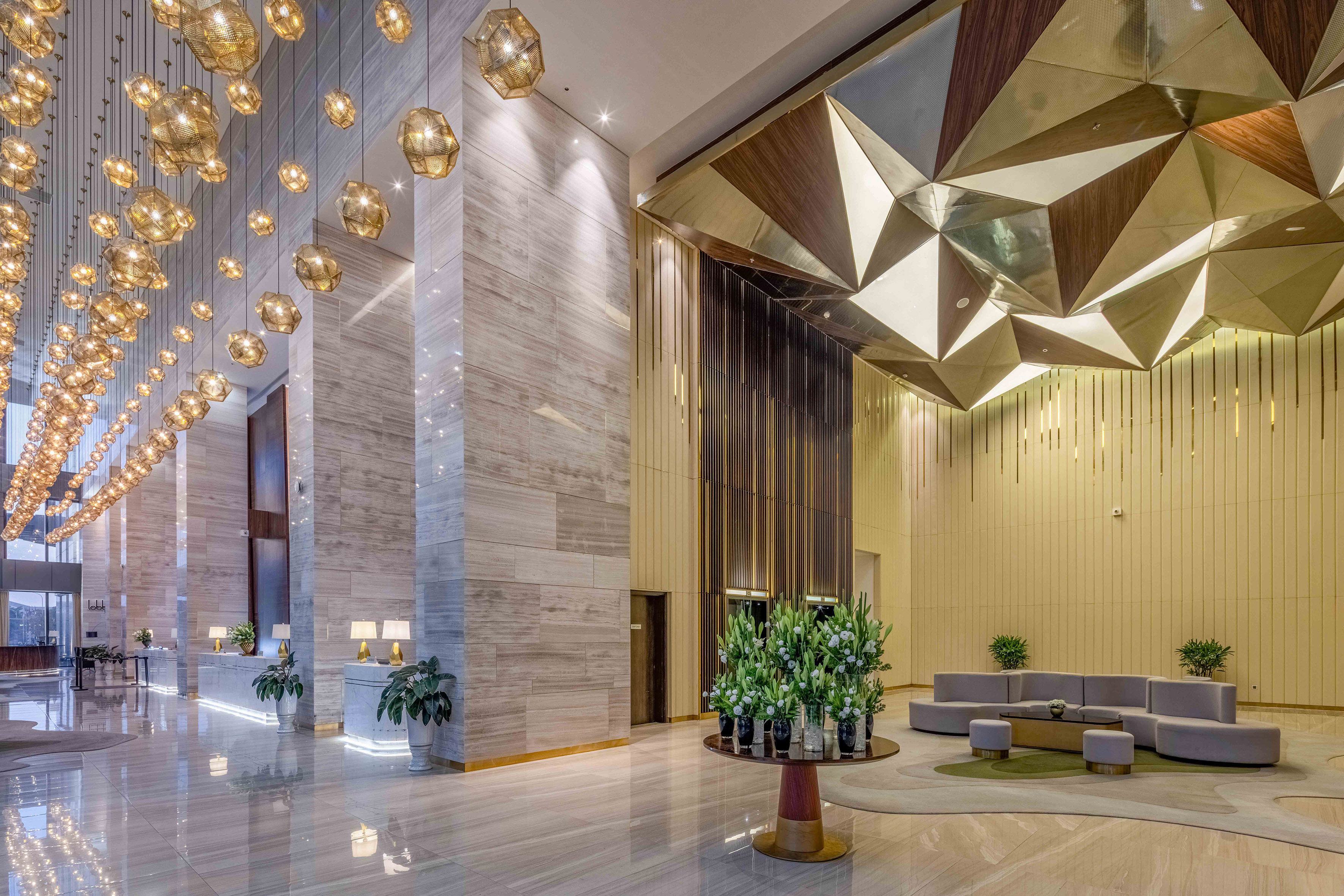 a lobby with a large chandelier and a couch