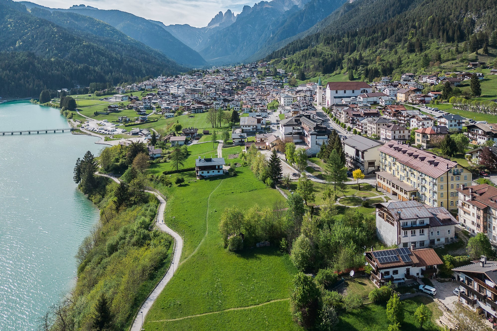 Auronzo di Cadore: Alpine village, turquoise lake, and towering Dolomites peaks.