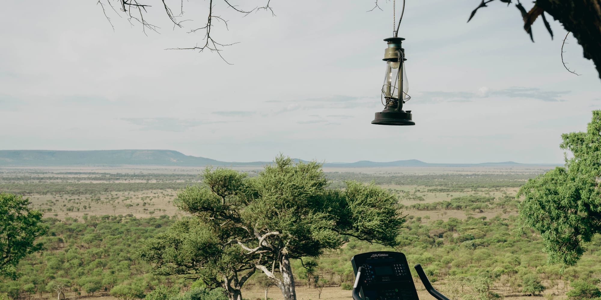 an exercise bike on a patio with a view of a landscape