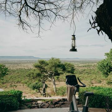 an exercise bike on a patio with a view of a landscape