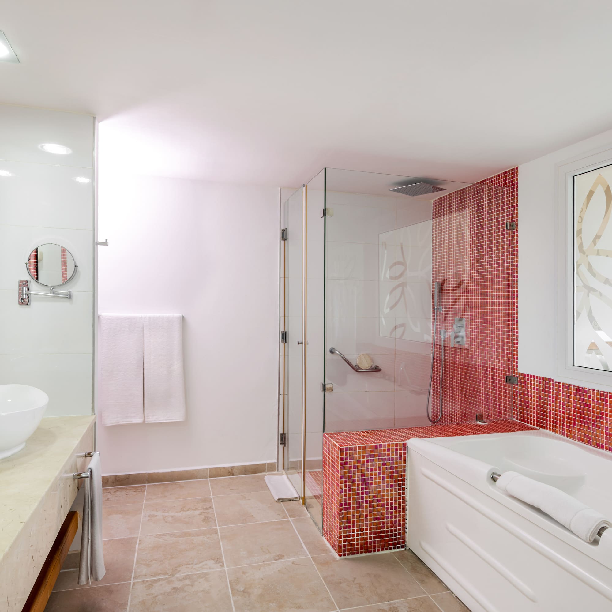 a bathroom with a glass shower and tub