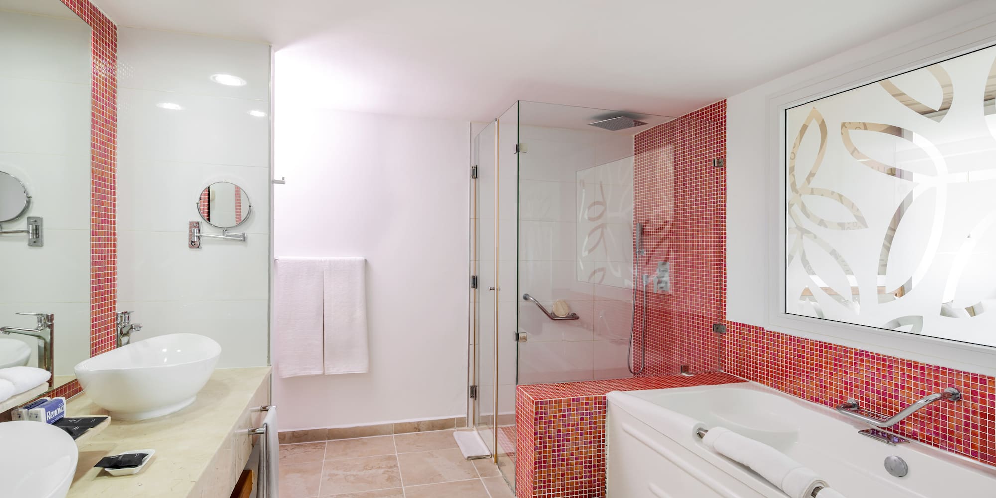 a bathroom with a glass shower and tub