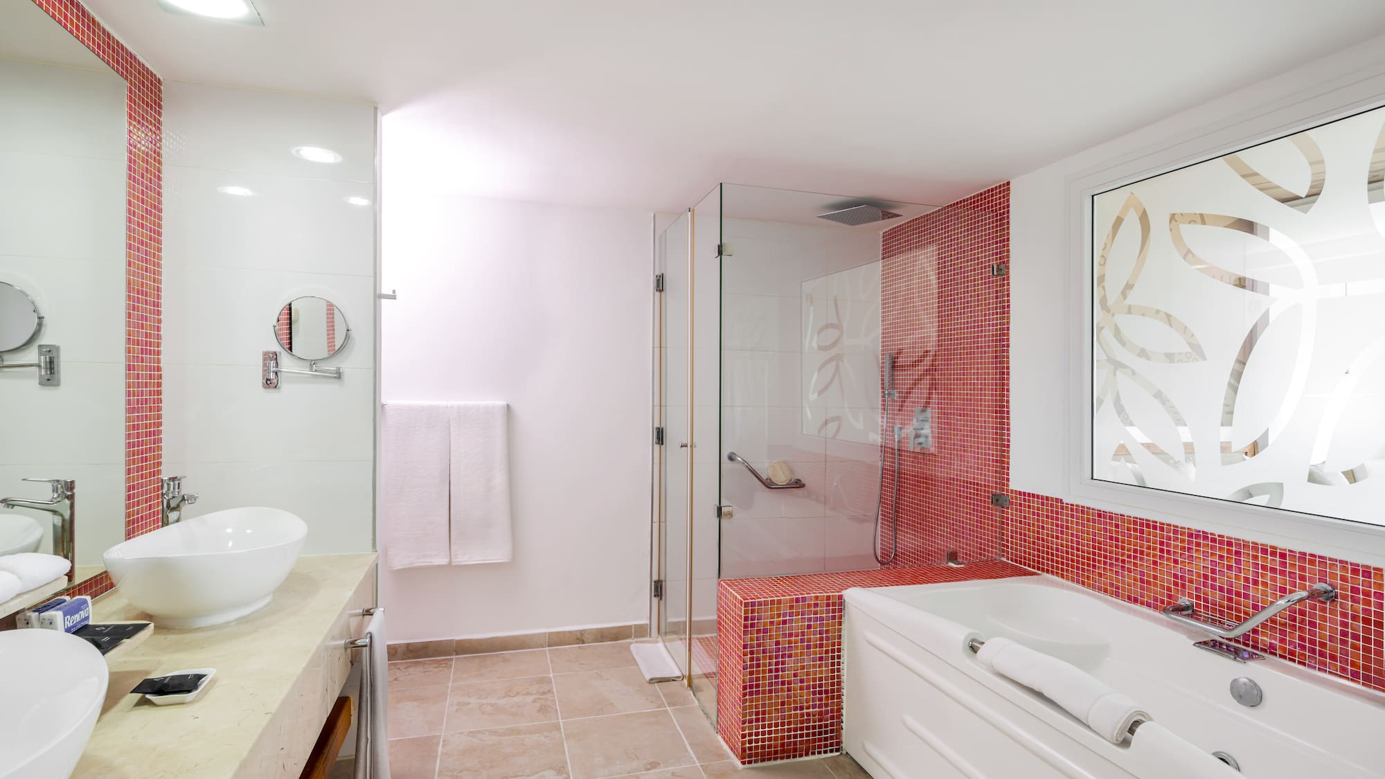 a bathroom with a glass shower and tub