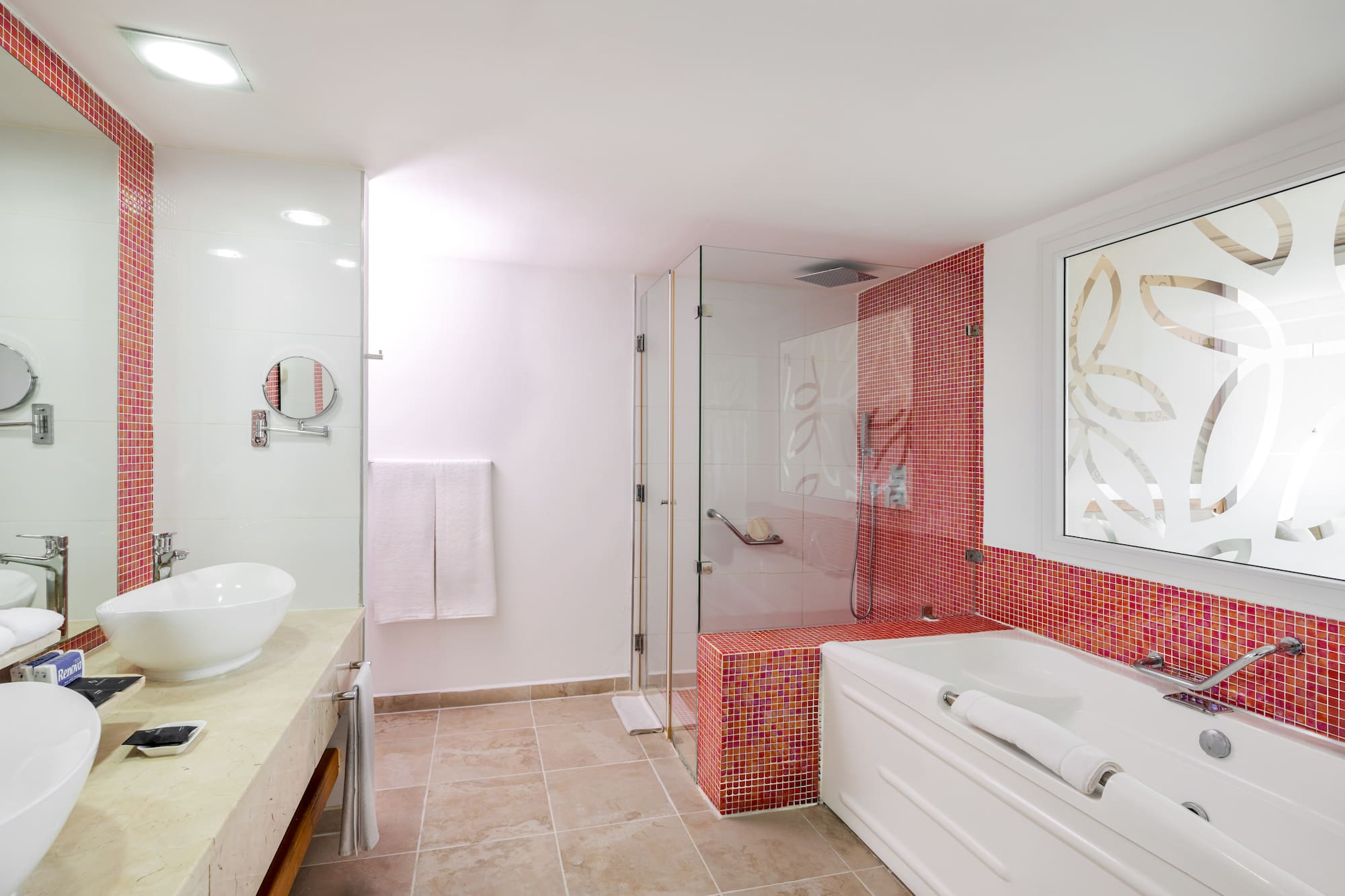 a bathroom with a glass shower and tub