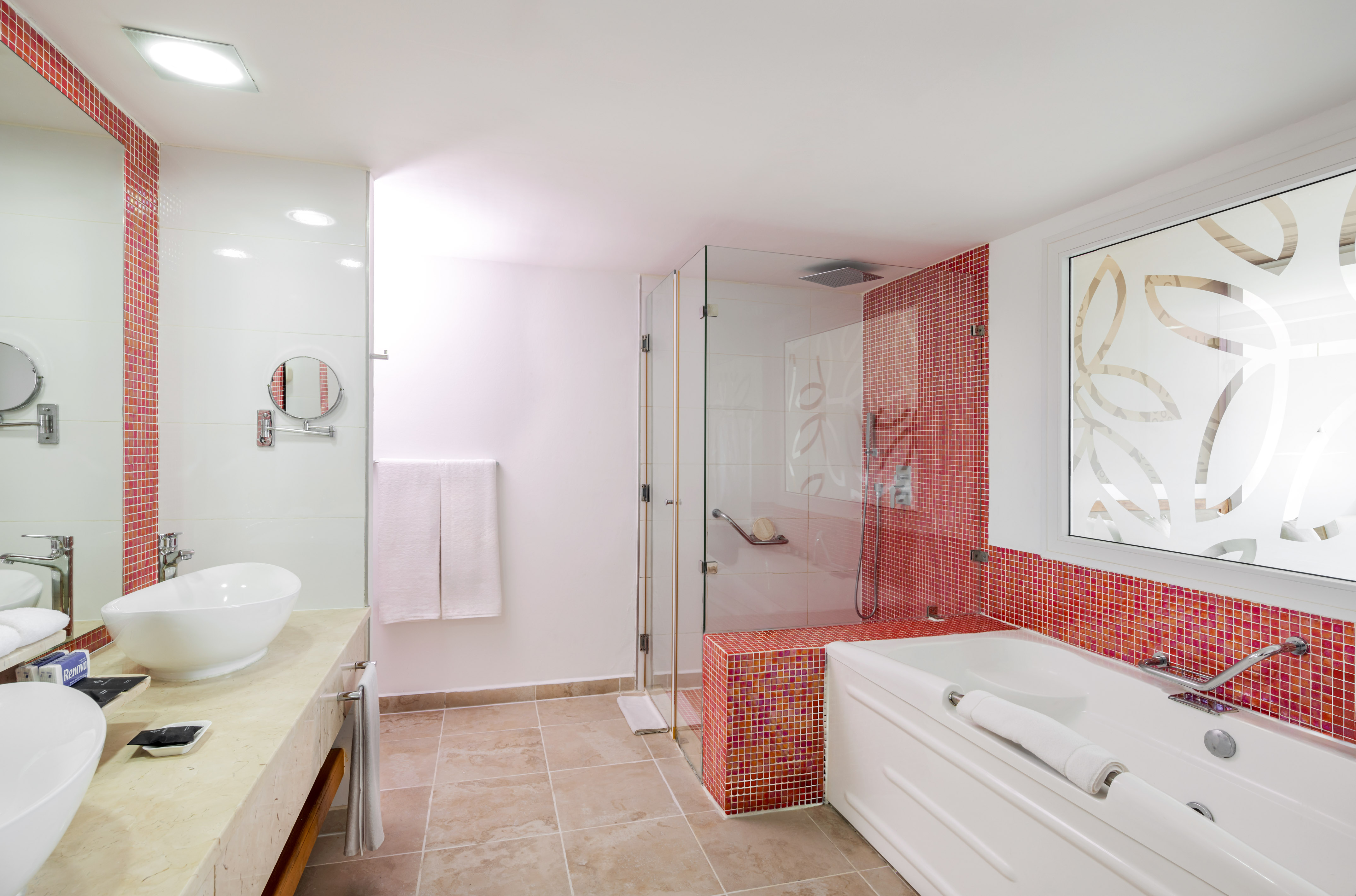 a bathroom with a glass shower and tub