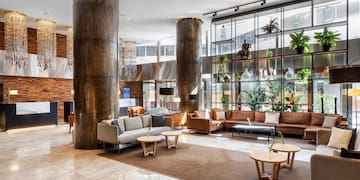 a large room with a large column and a large couch