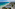 a beach with buildings and trees