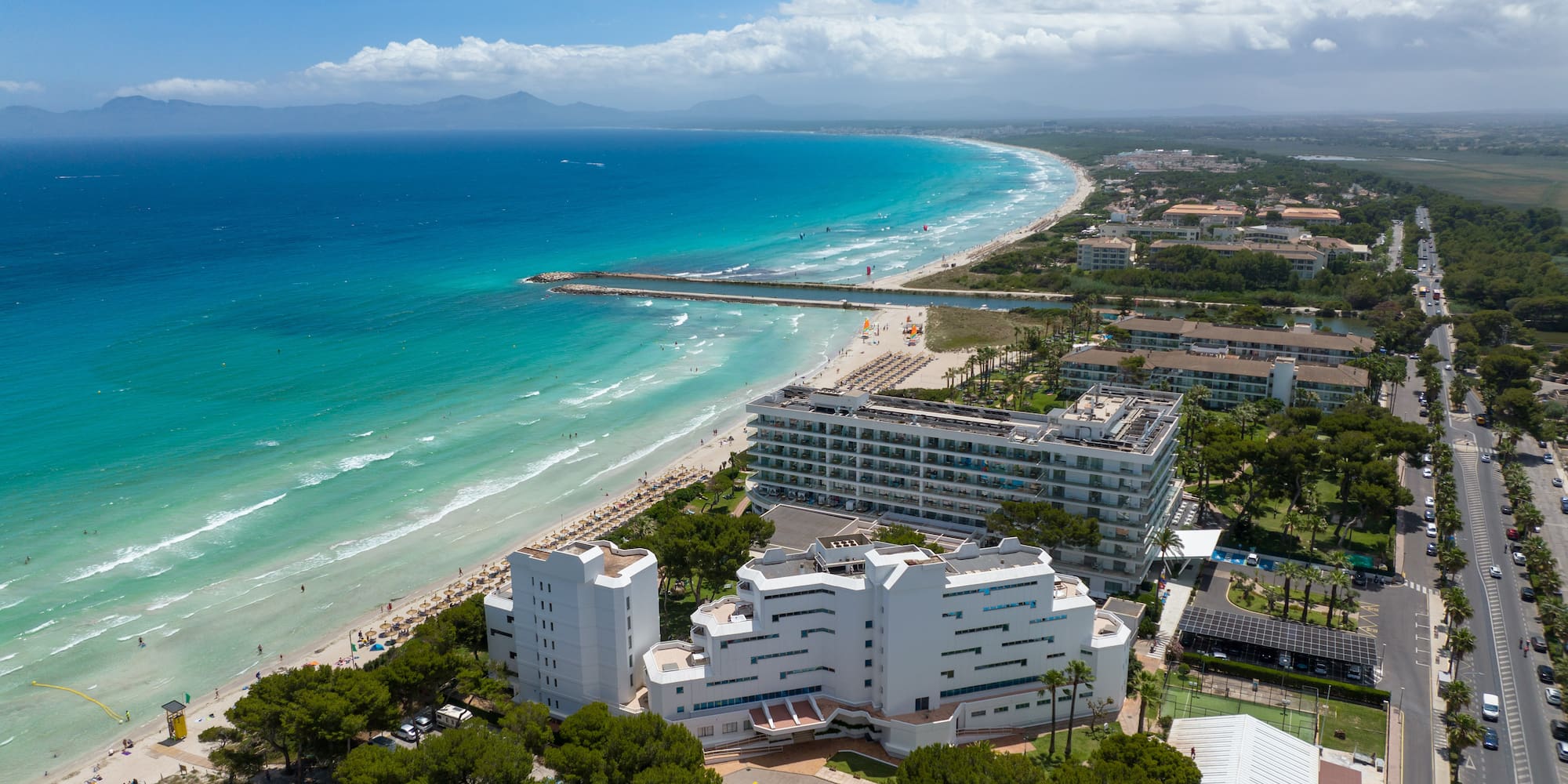 a beach with buildings and trees