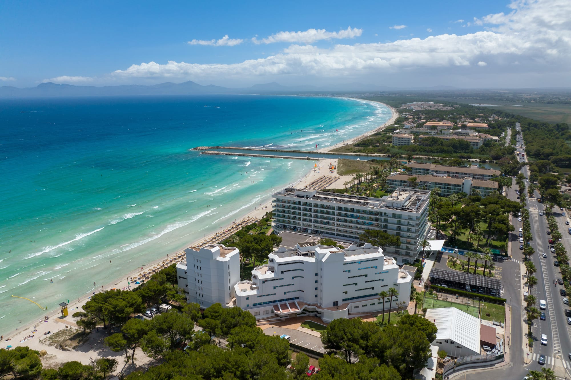 a beach with buildings and trees