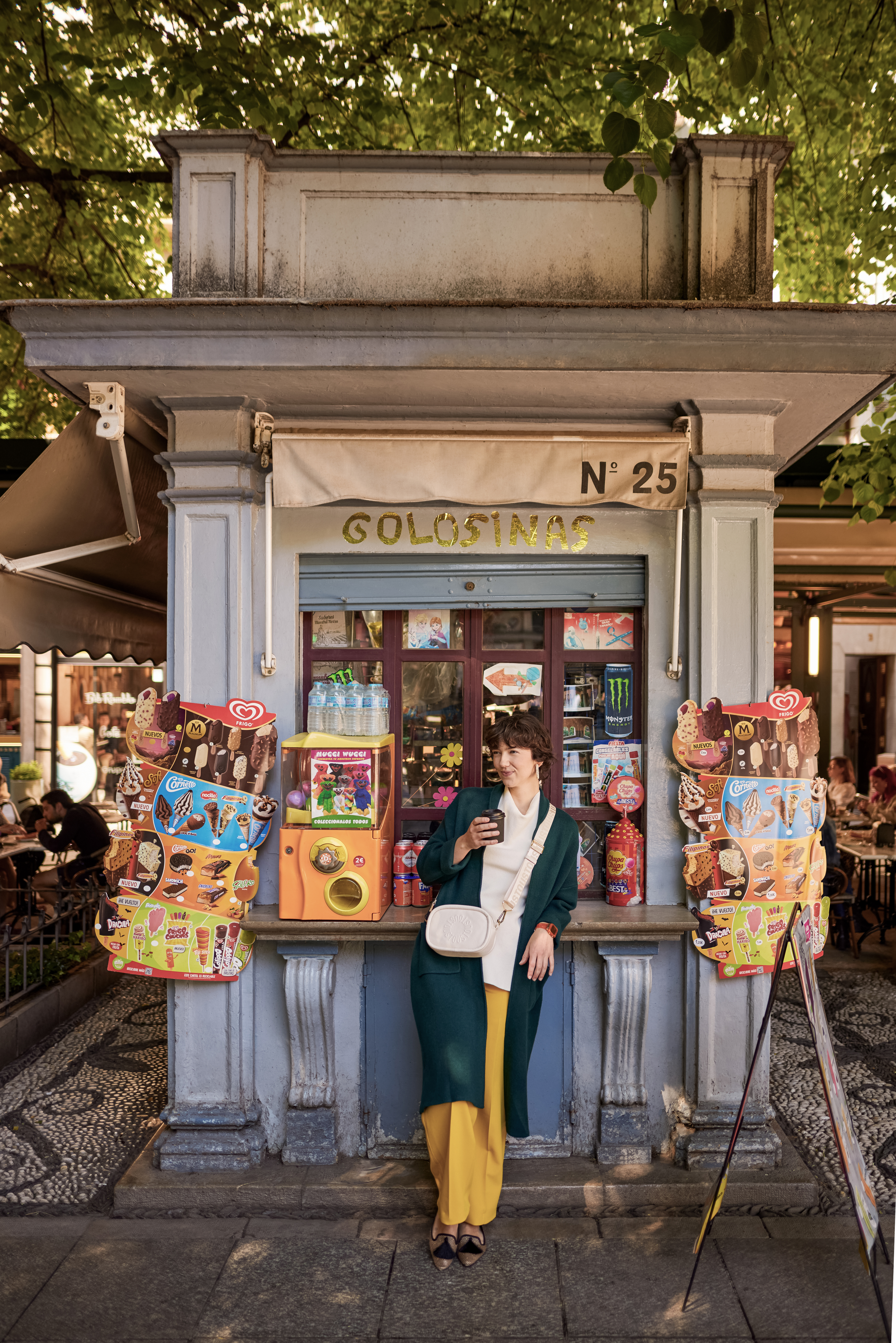 a woman standing in front of a small store