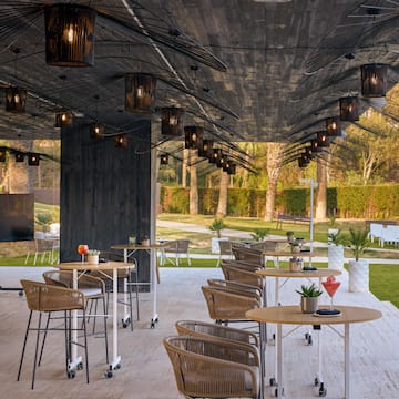 a patio with tables and chairs