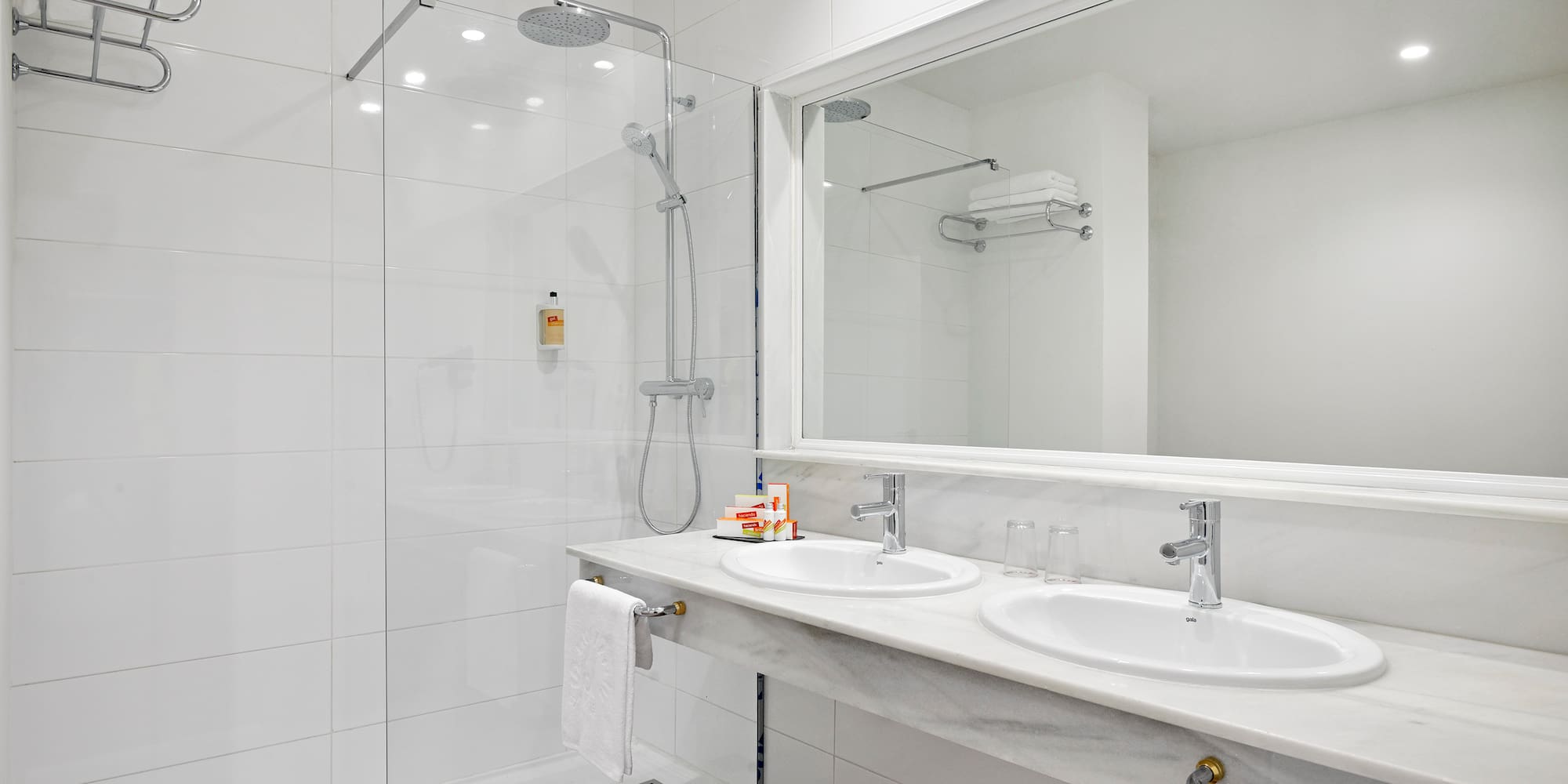 a bathroom with a shower and two sinks