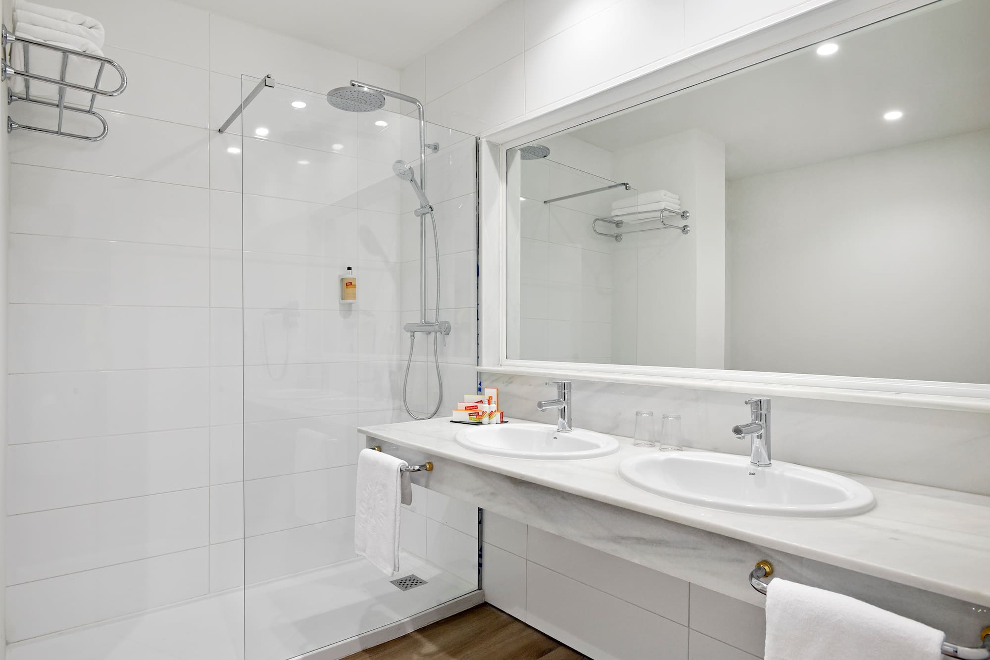 a bathroom with a shower and two sinks