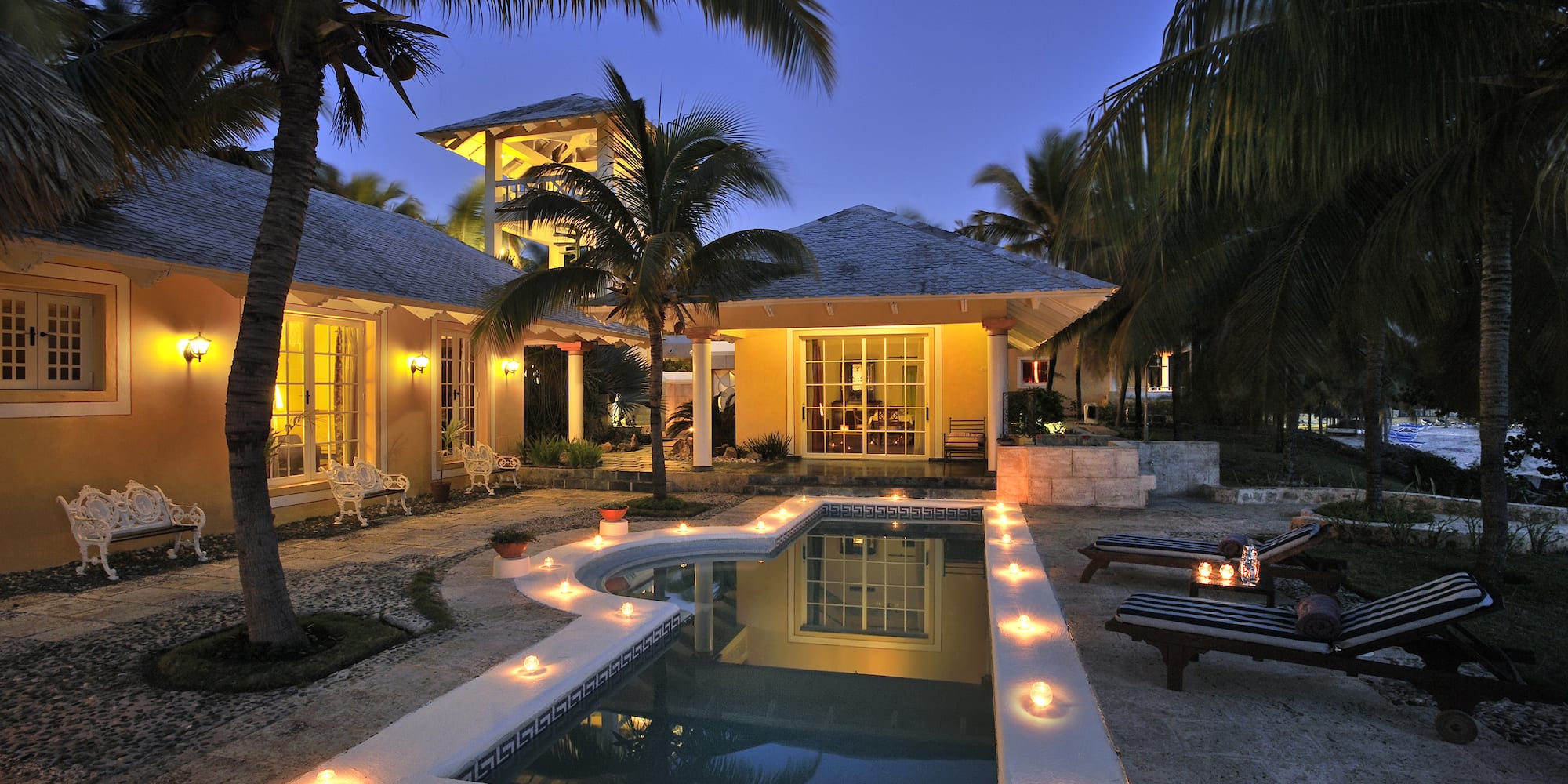 a pool with candles in the middle of a house