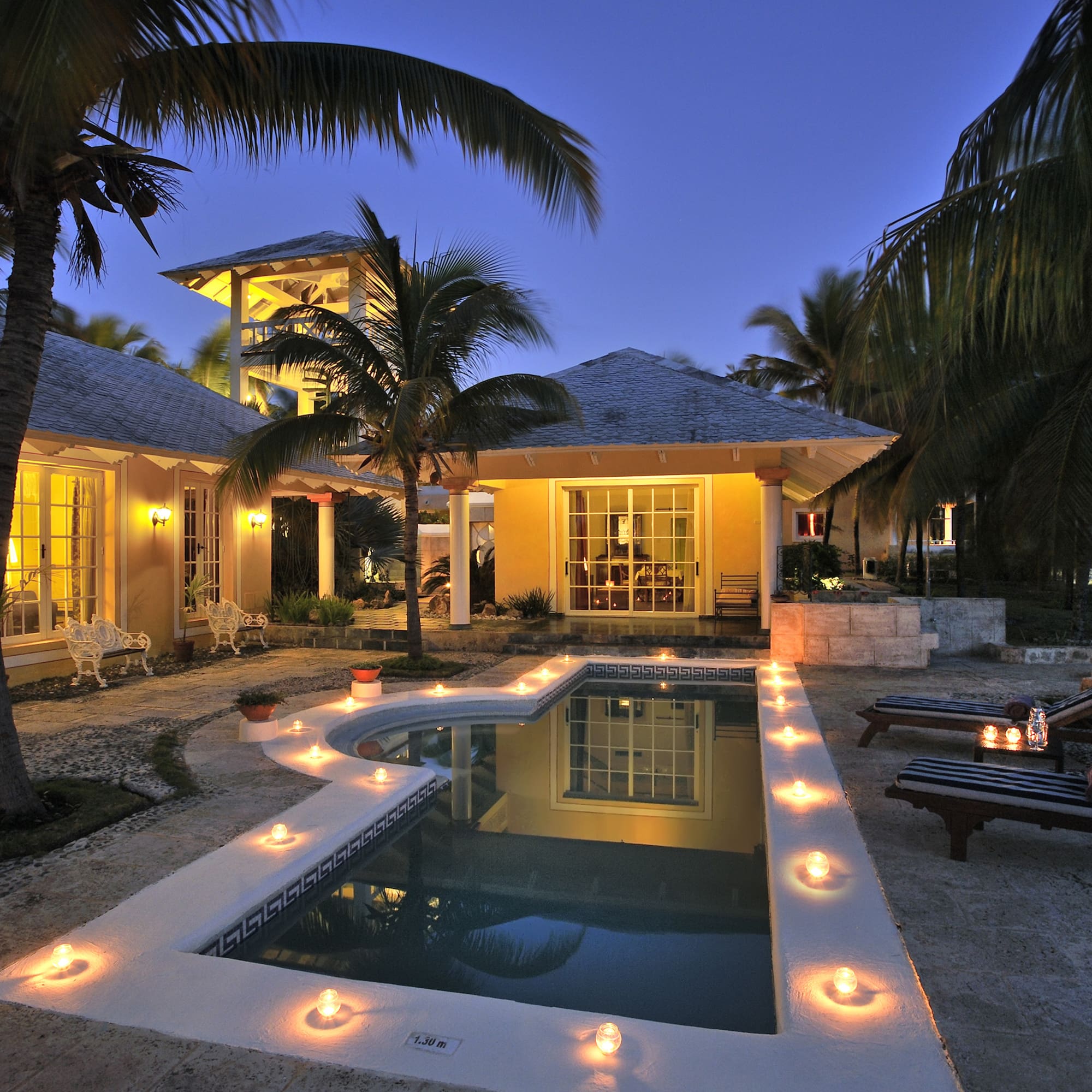 a pool with candles in the middle of a house
