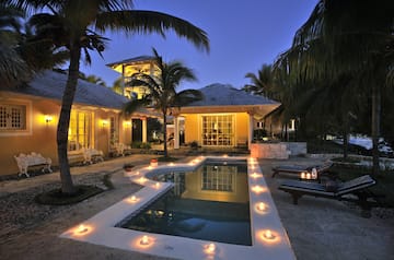 a pool with candles in the middle of a house