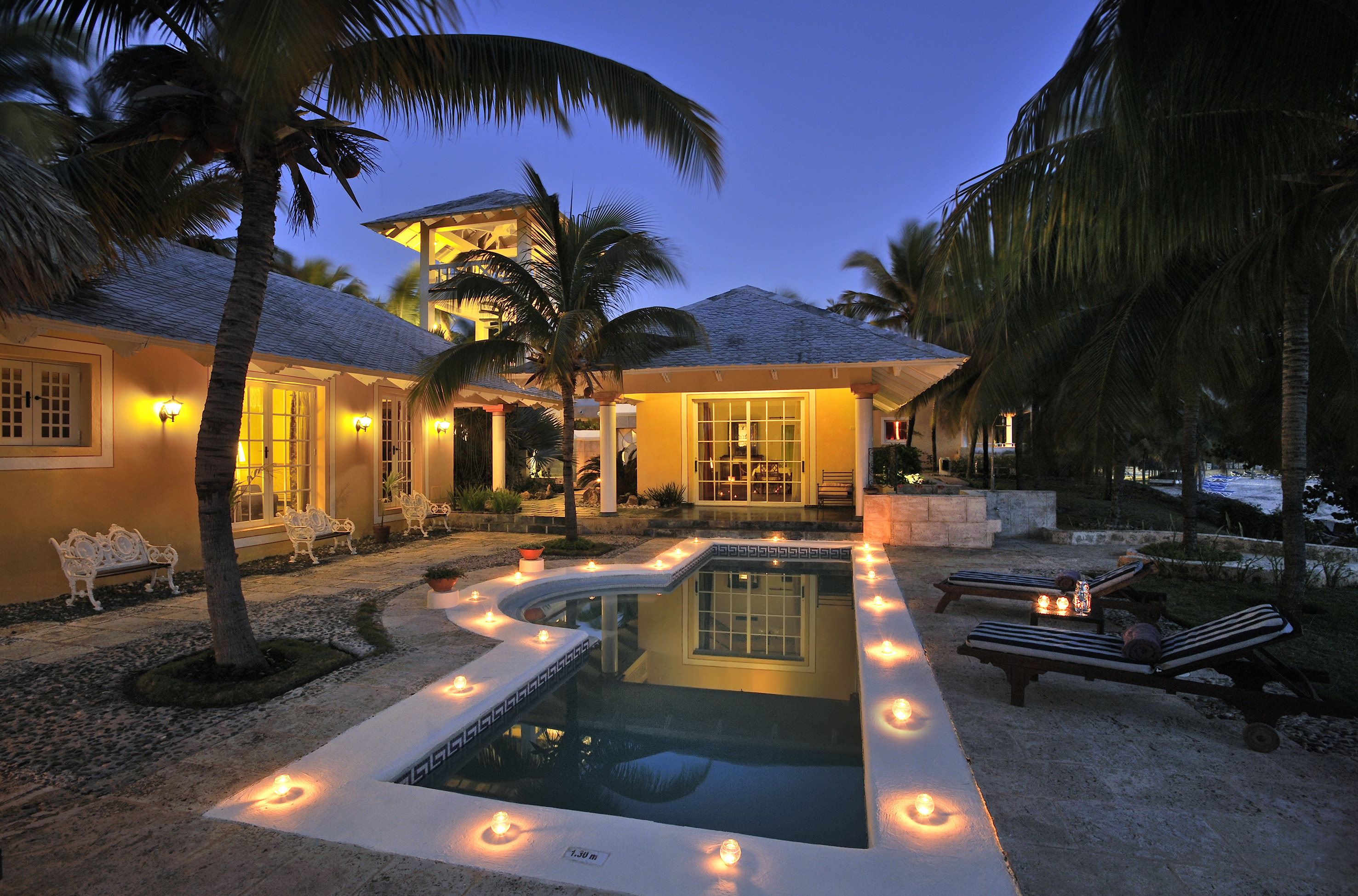 a pool with candles in the middle of a house