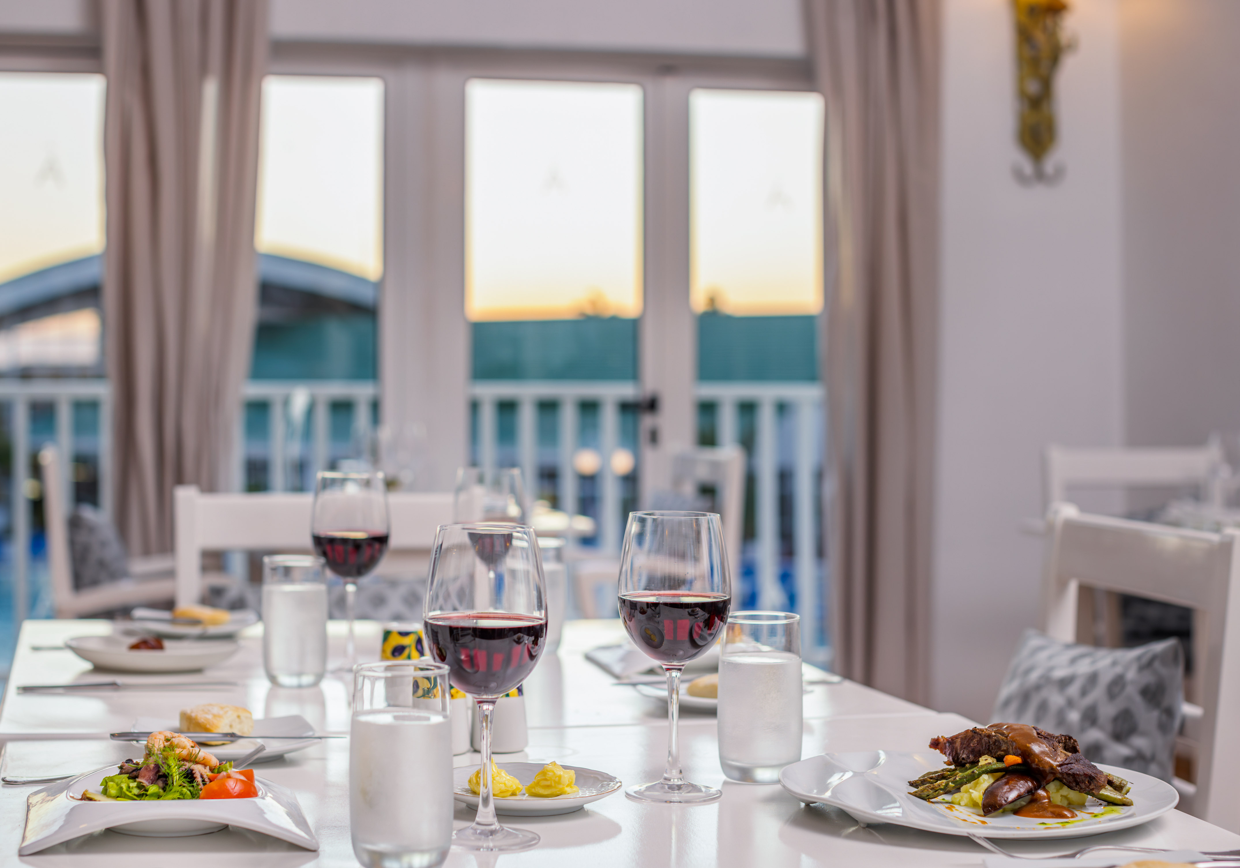a table with food and wine glasses on it