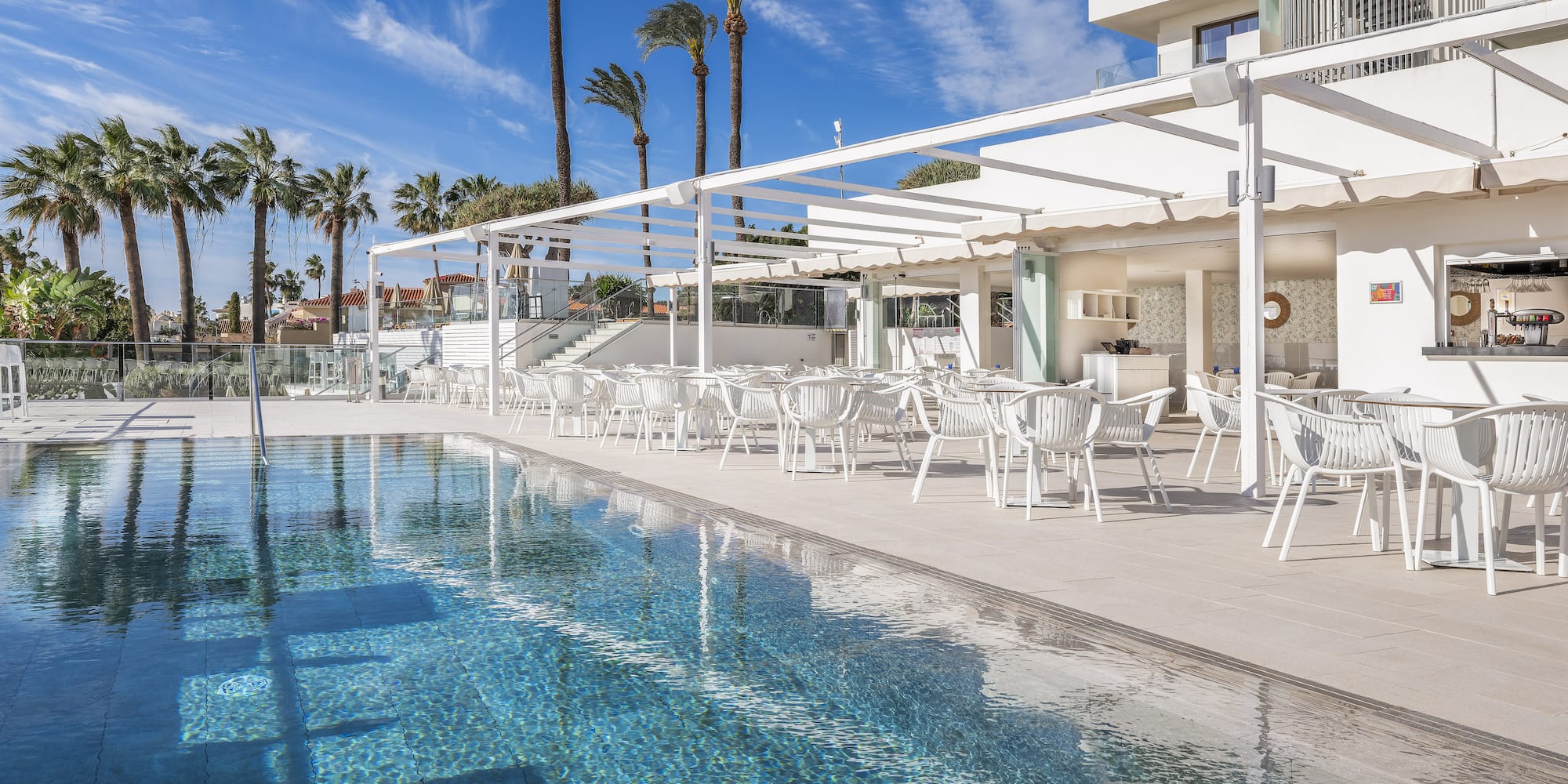 a pool with tables and chairs