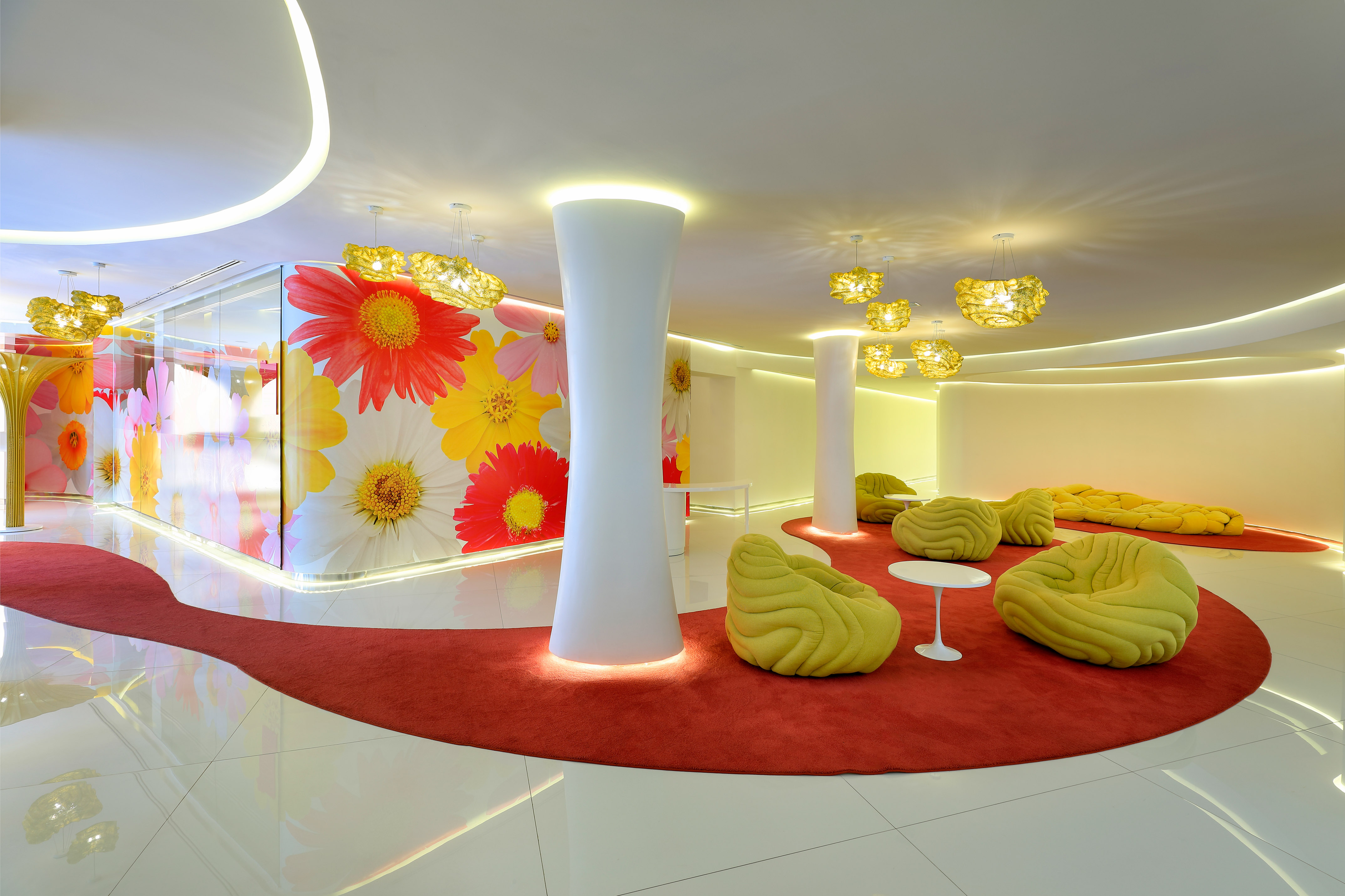 a room with a red carpet and yellow chairs