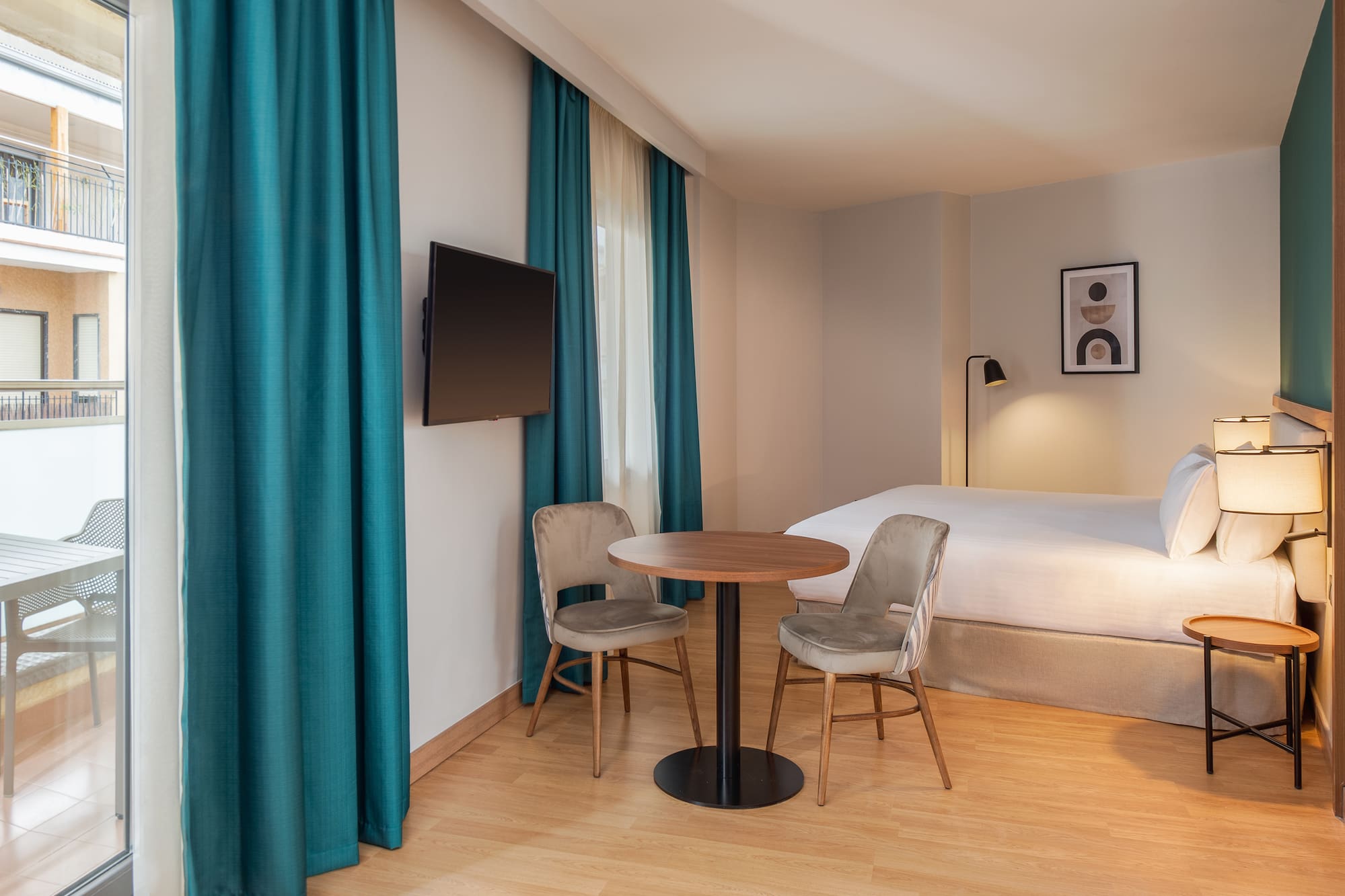 a room with a bed and a table and chairs