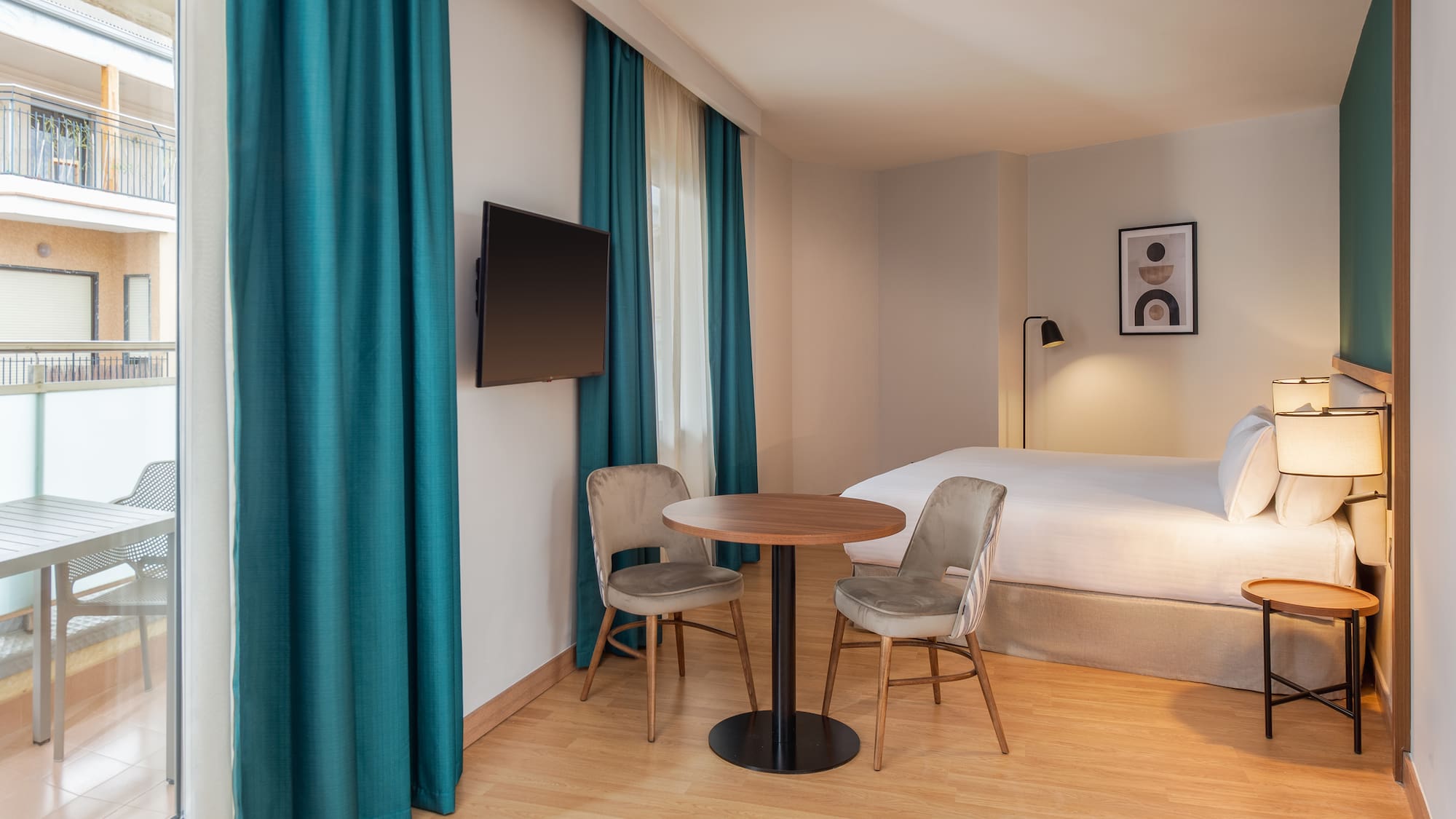 a room with a bed and a table and chairs