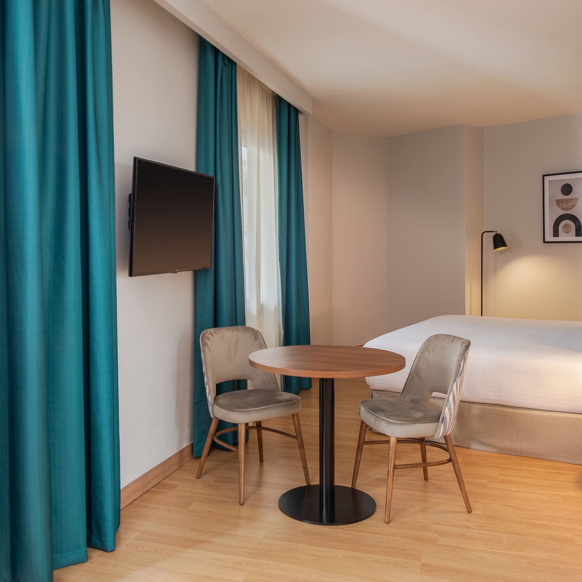 a room with a bed and a table and chairs