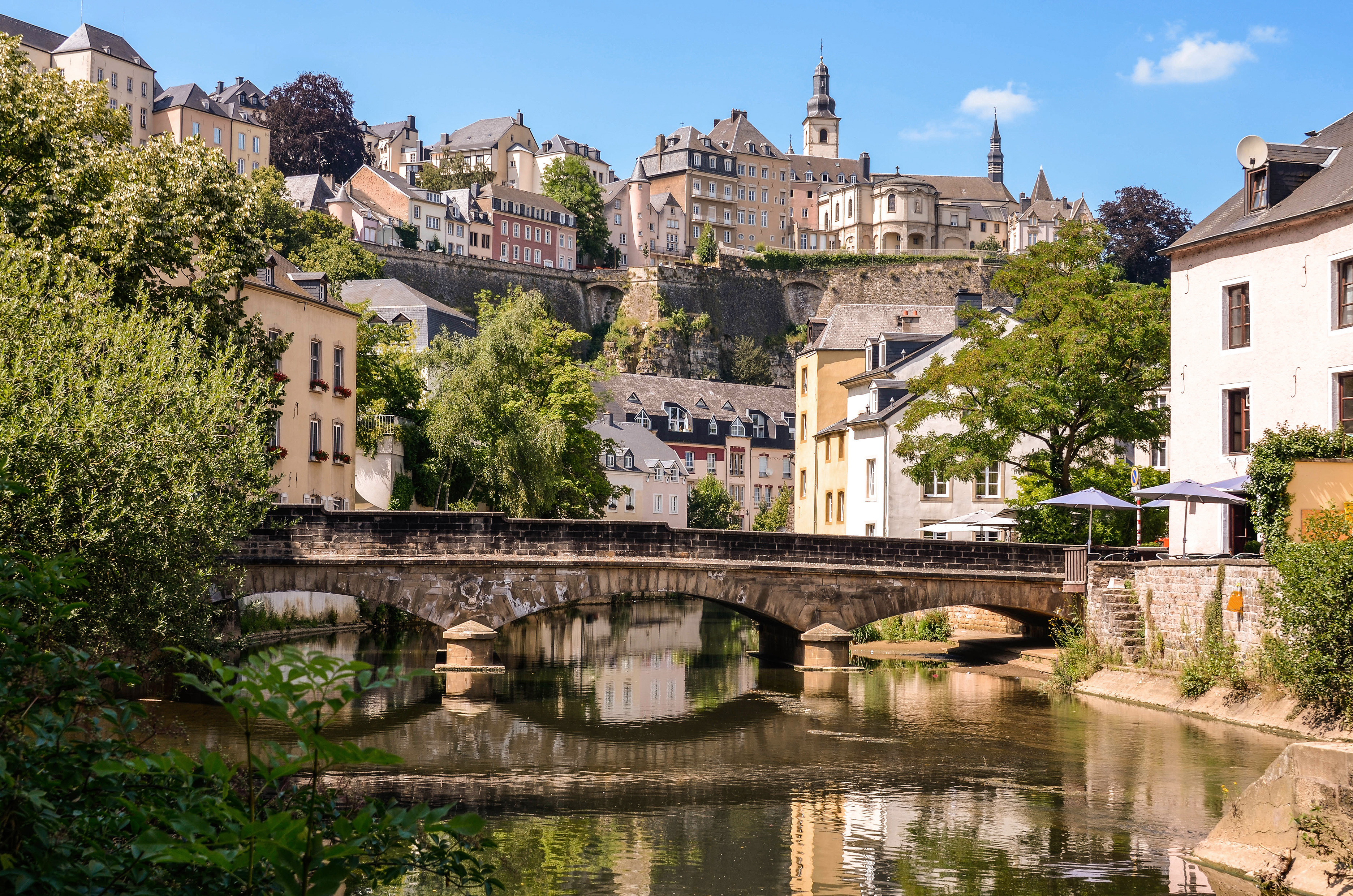 a bridge over a river with buildings in the background
