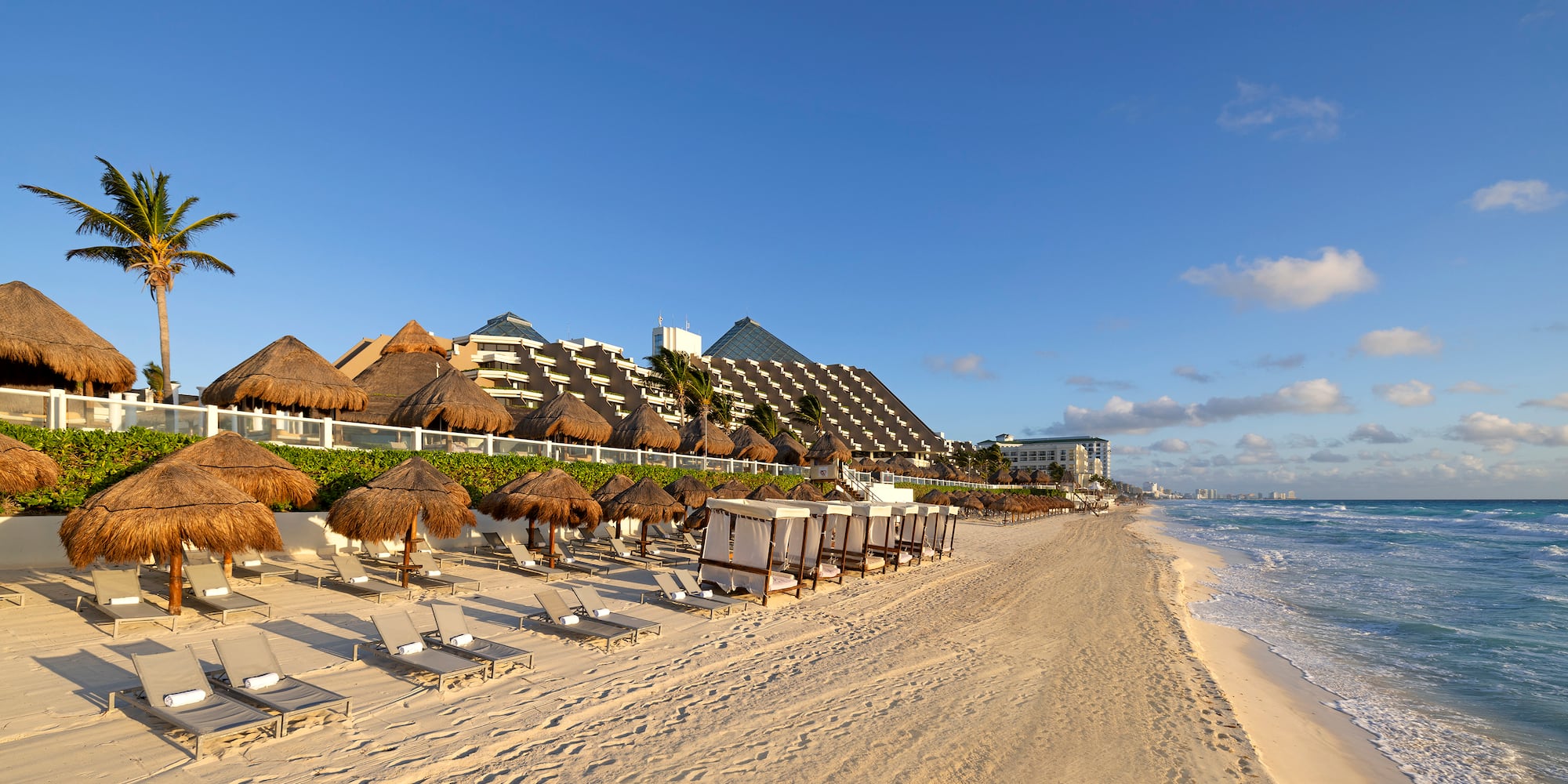 a beach with chairs and umbrellas
