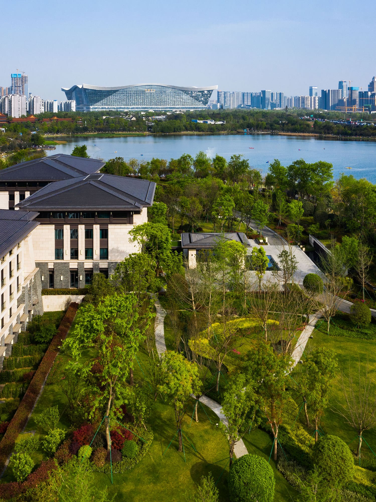 a large building with trees and a body of water