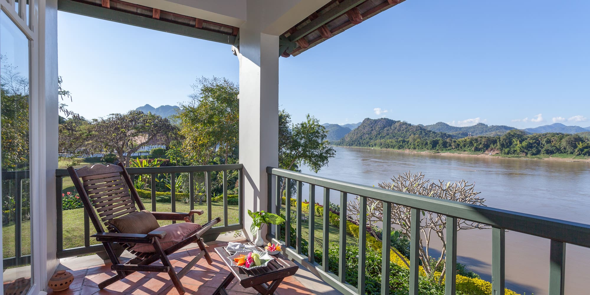 a chair on a porch overlooking a river