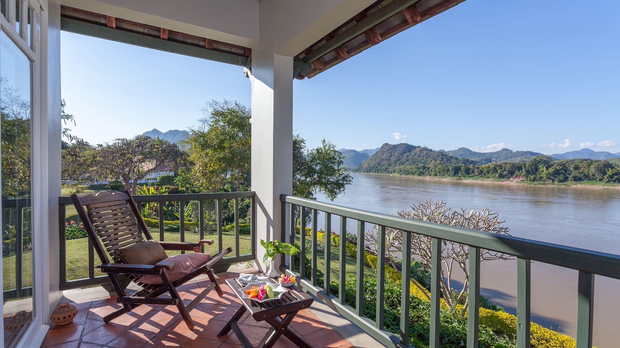 a chair on a porch overlooking a river