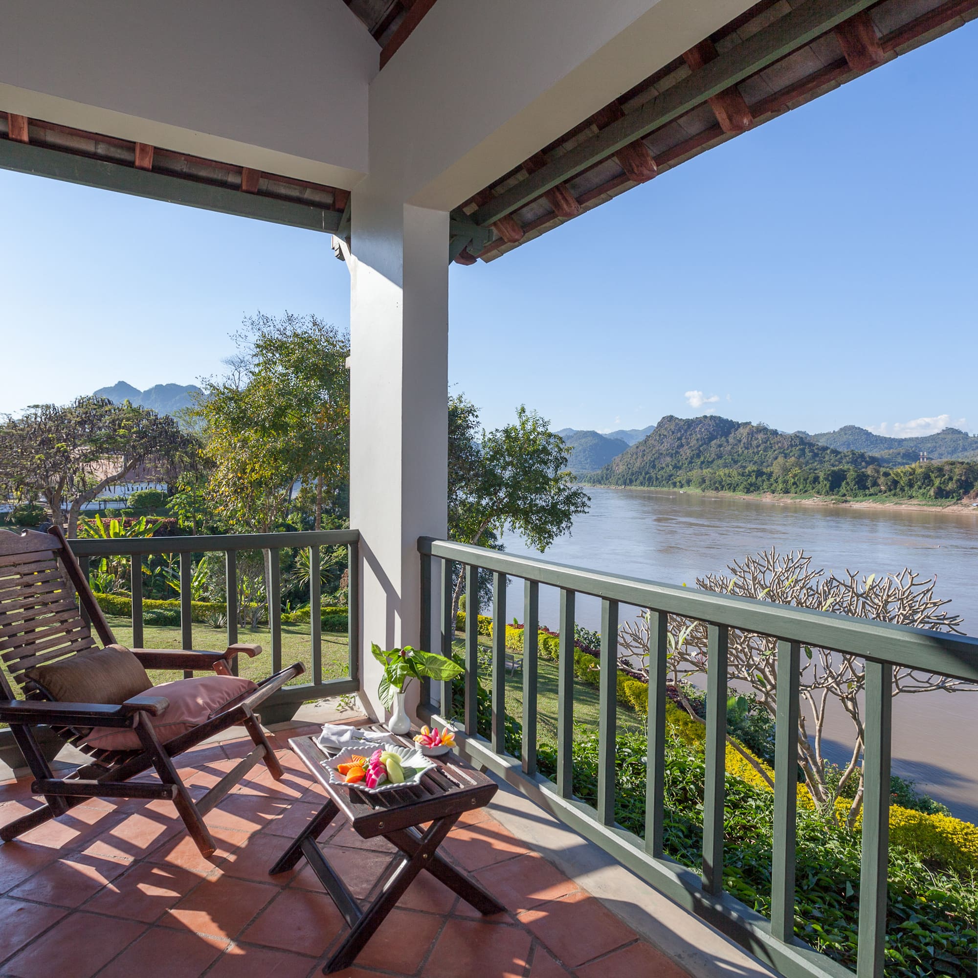 a chair on a porch overlooking a river