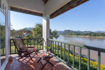 a chair on a porch overlooking a river
