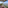 Scenic balcony with river and mountain views, wooden chair, snack table.