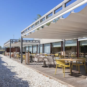 a patio with tables and chairs