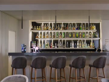 a bar with a shelf of liquor bottles