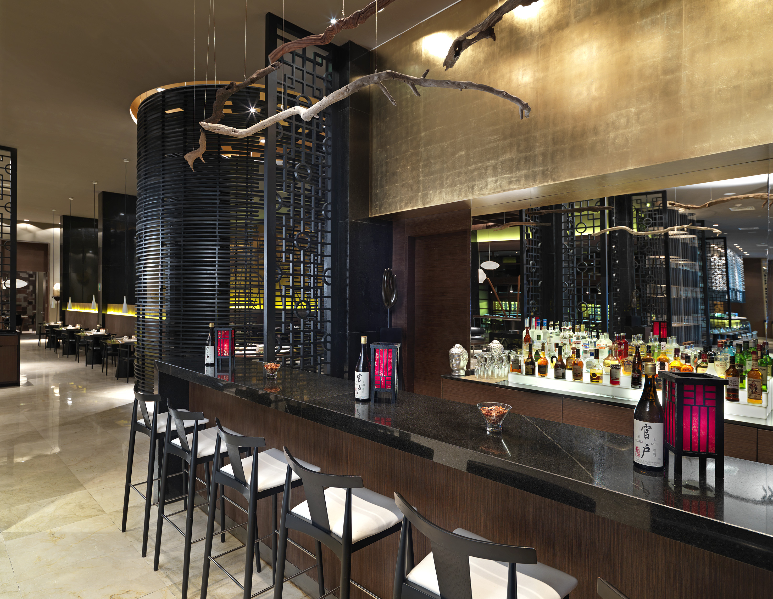 a bar with bottles and stools