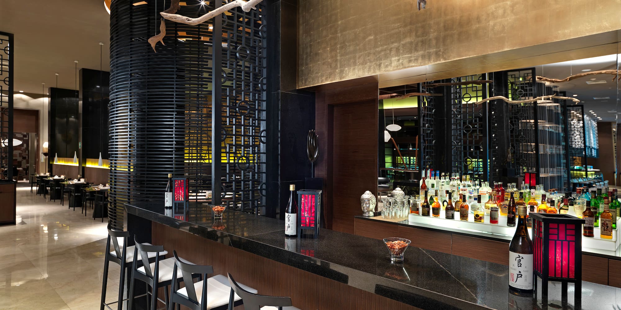 a bar with bottles and stools