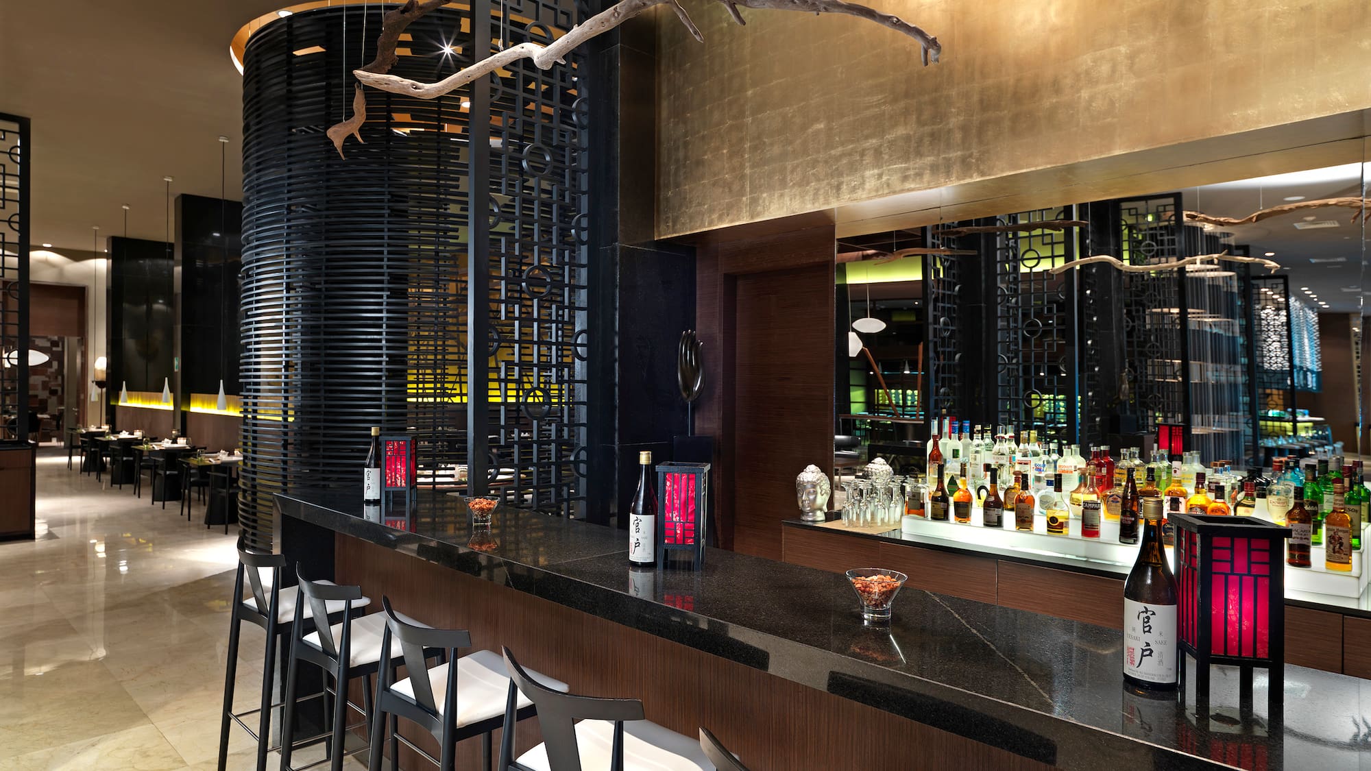 a bar with bottles and stools