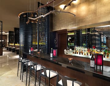 a bar with bottles and stools