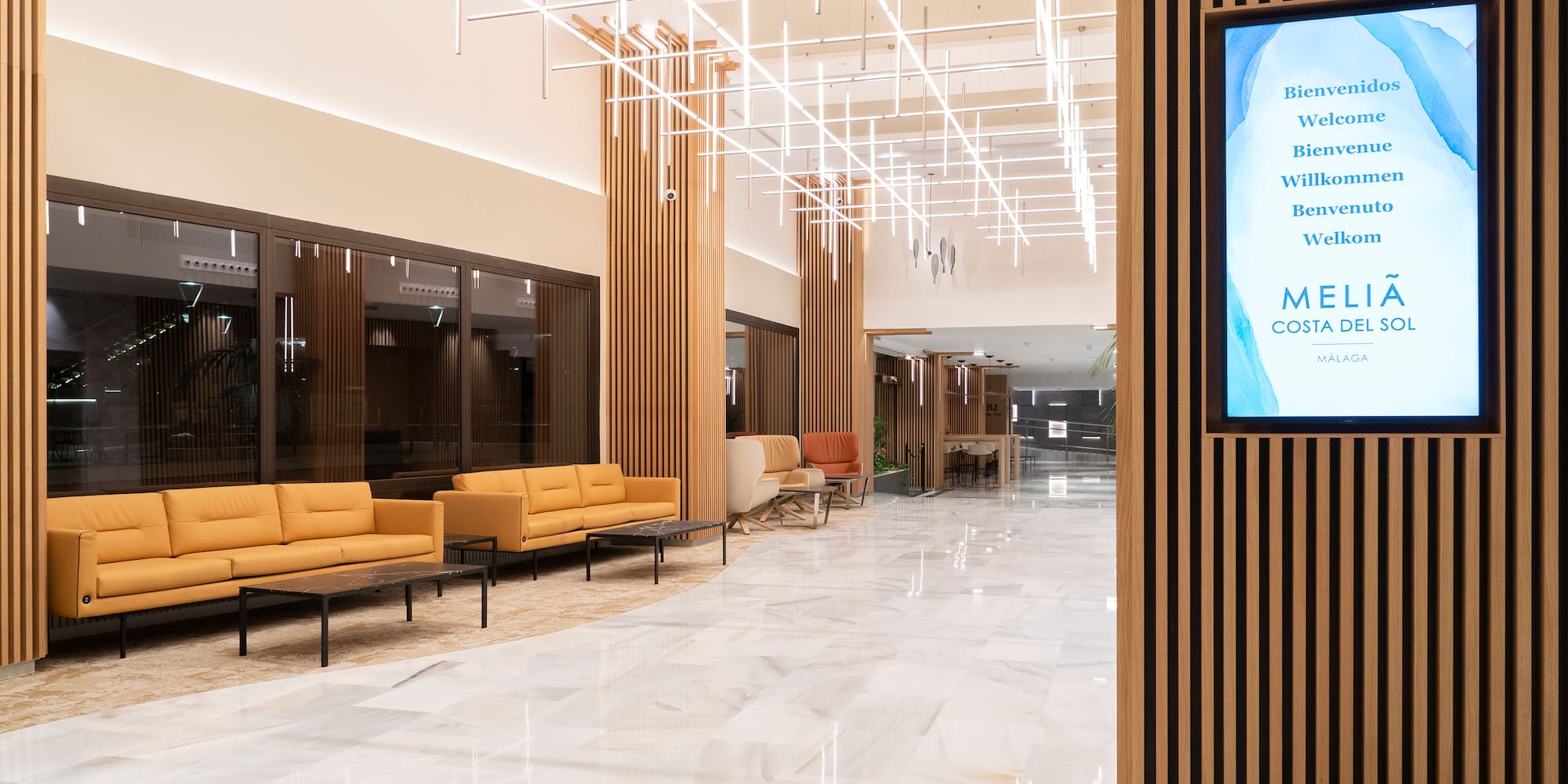 a large room with a television screen and chairs